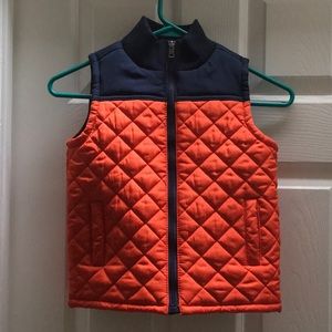 Cute boys vest. Bright orange with navy trim.